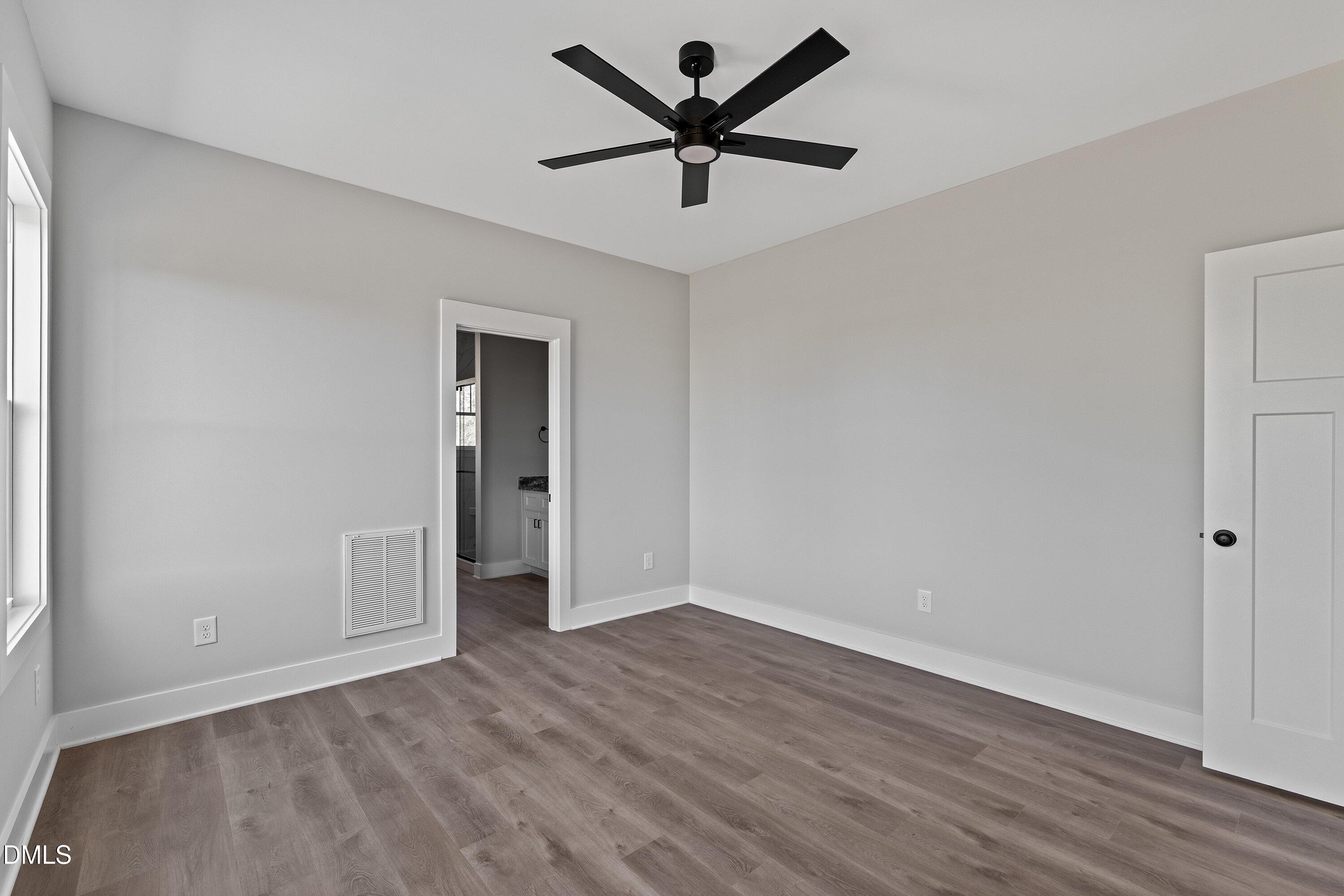 9400 Turkey Way Middlesex, NC 27557 - Photo 14 of 31 a view of a room with wooden floor and a ceiling fan