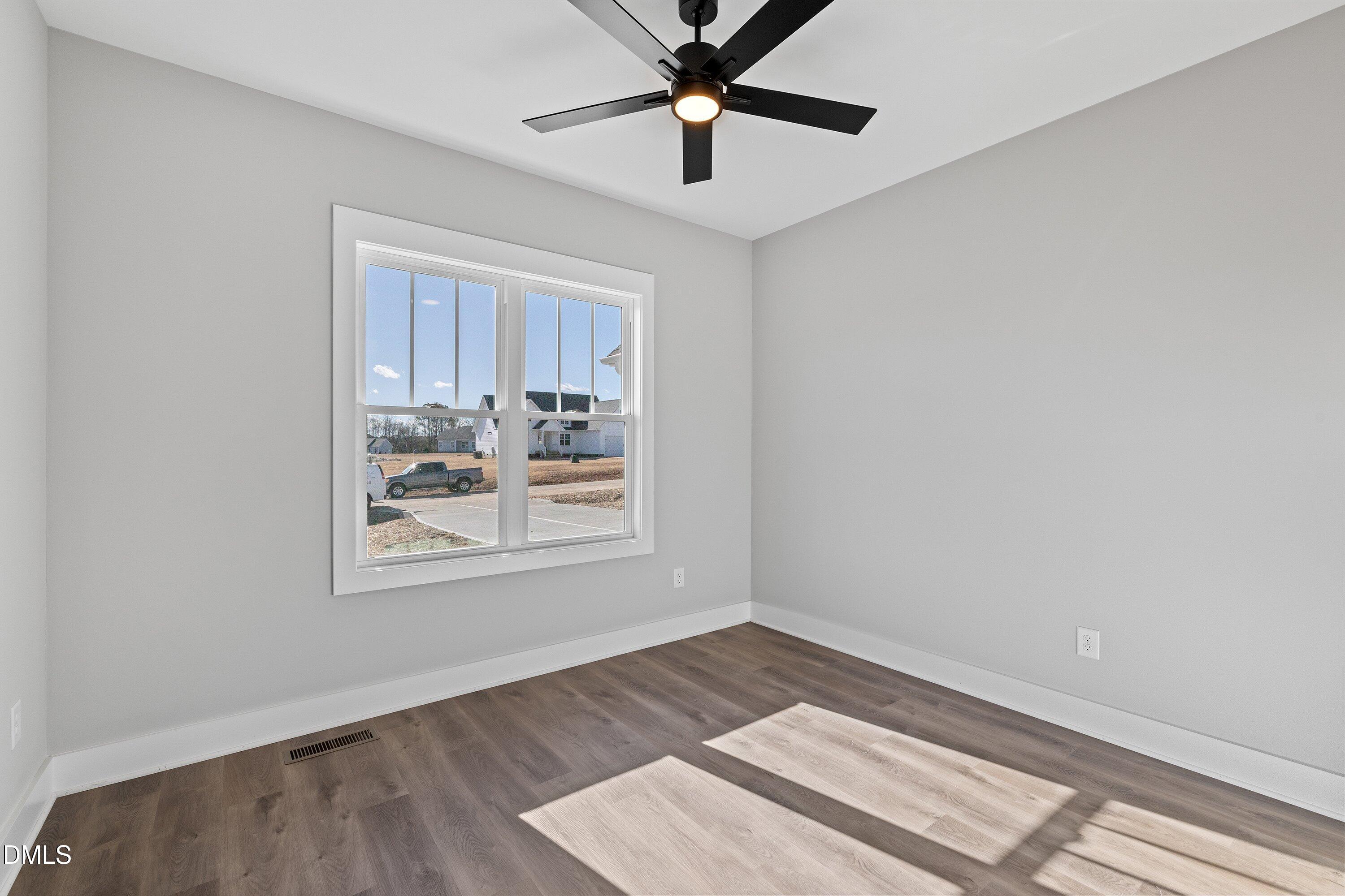 9400 Turkey Way Middlesex, NC 27557 - Photo 18 of 31 a view of wooden floor and a chandelier fan in a room