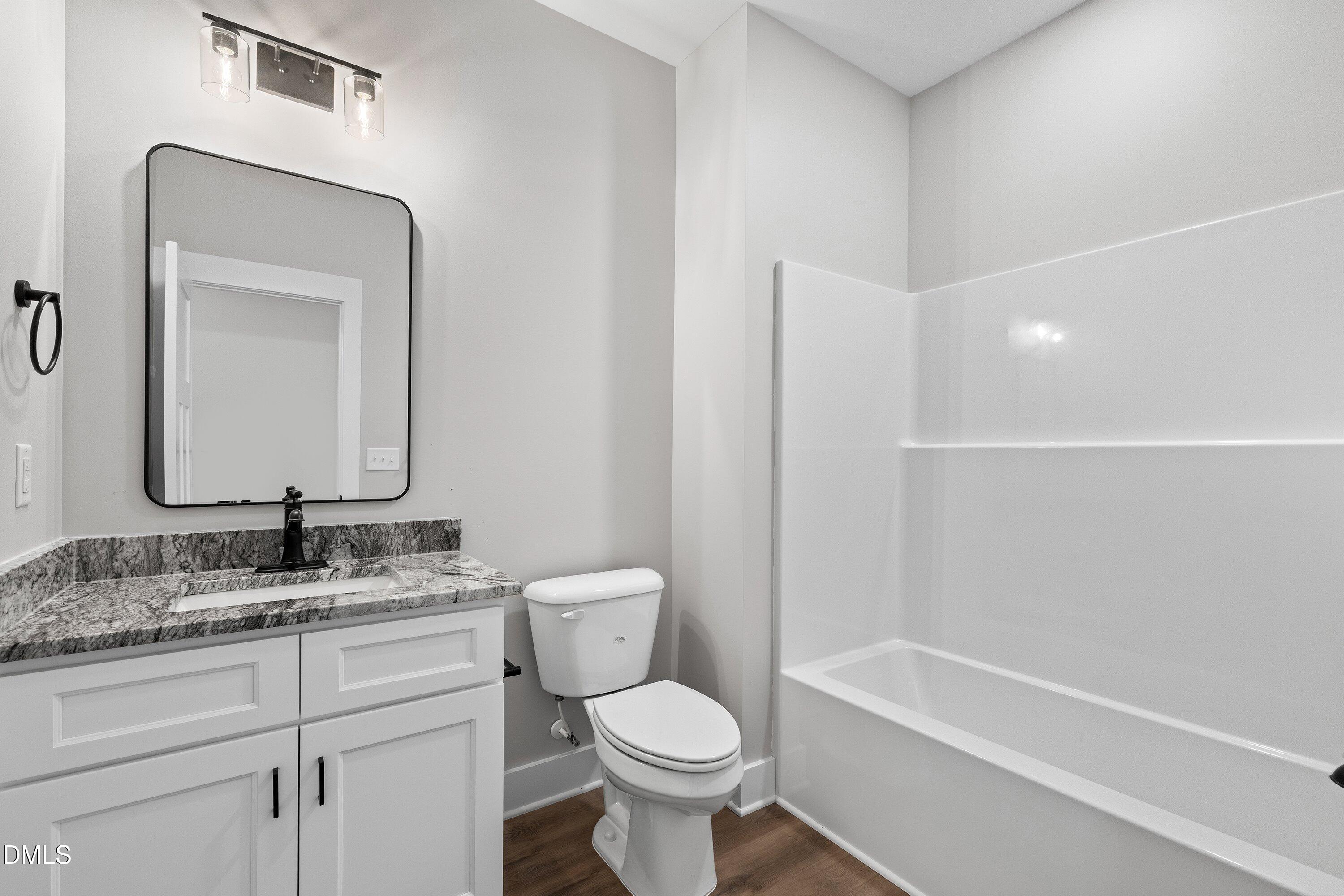 9400 Turkey Way Middlesex, NC 27557 - Photo 20 of 31 a bathroom with a toilet sink and mirror