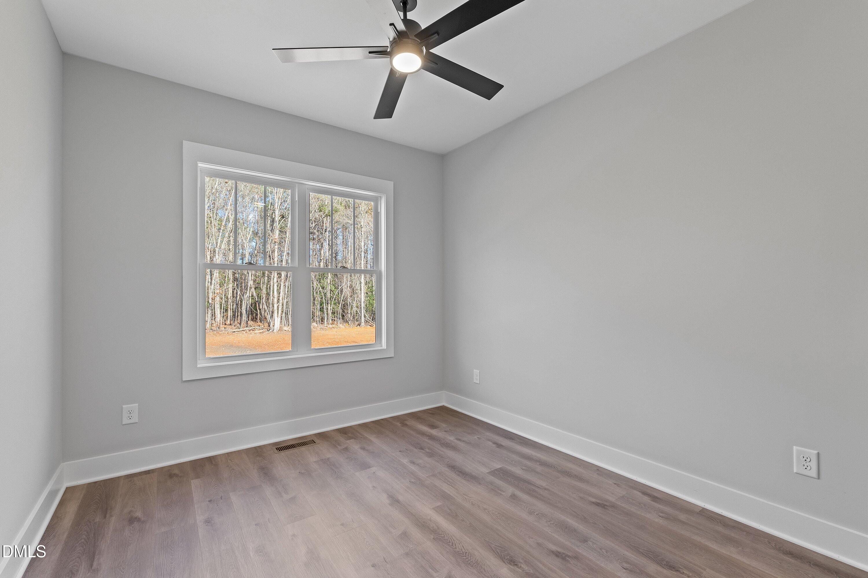 9400 Turkey Way Middlesex, NC 27557 - Photo 21 of 31 an empty room with a window and ceiling fan