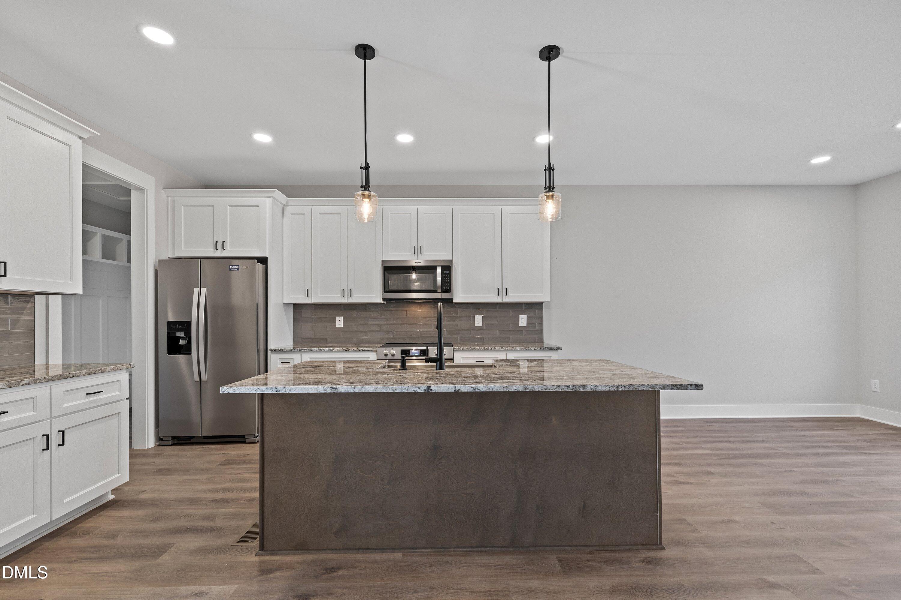 9400 Turkey Way Middlesex, NC 27557 - Photo 5 of 31 a kitchen with stainless steel appliances granite countertop a sink a stove a refrigerator a center island and cabinets