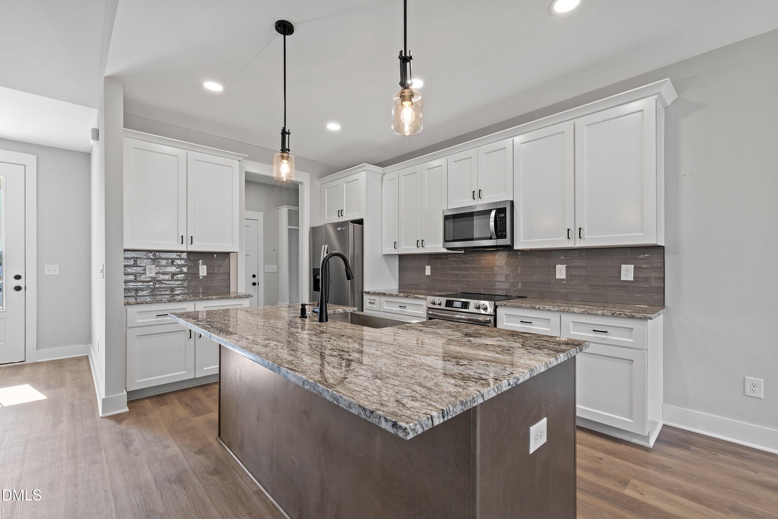 9400 Turkey Way Middlesex, NC 27557 - Photo 6 of 31 a kitchen with stainless steel appliances granite countertop a sink refrigerator and microwave