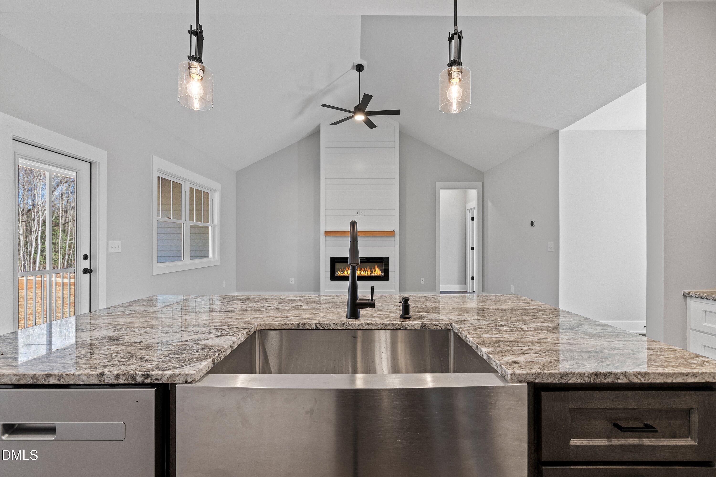 9400 Turkey Way Middlesex, NC 27557 - Photo 9 of 31 a kitchen with granite countertop a sink and a refrigerator
