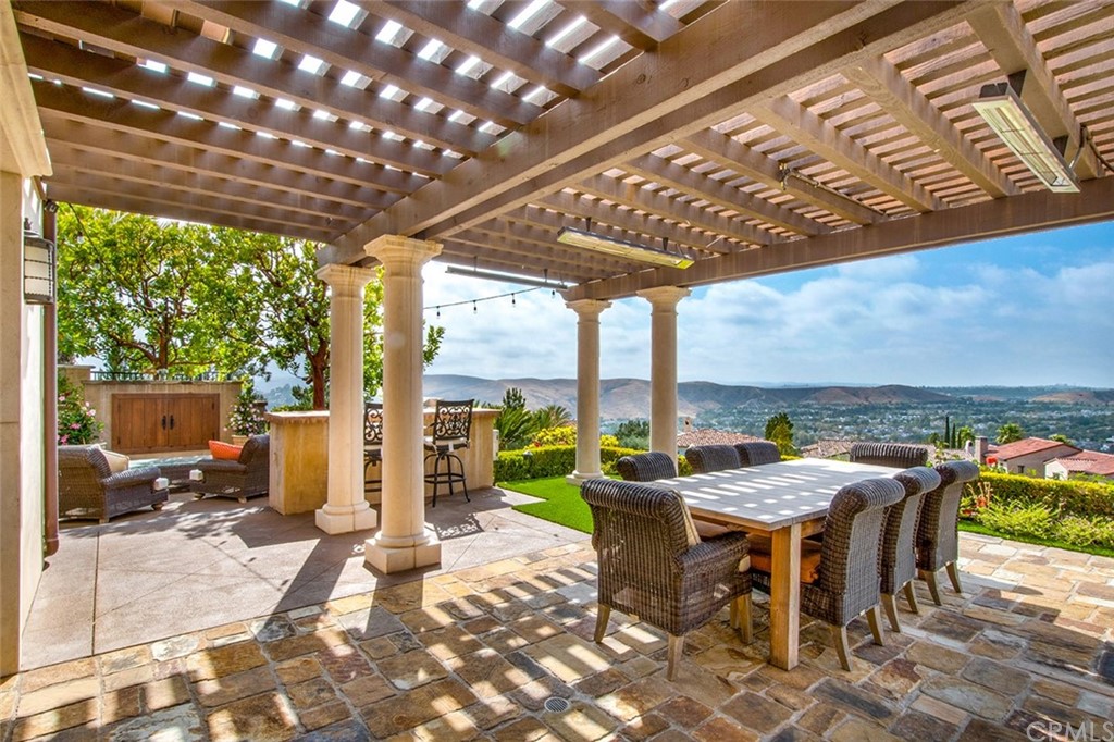 1 Thomas Road Ladera Ranch, CA 92694 - Photo 20 of 25 a view of a patio with a table chairs and backyard