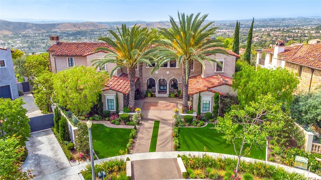 1 Thomas Road Ladera Ranch, CA 92694 - Photo 4 of 25 a front view of a house with a garden and plants