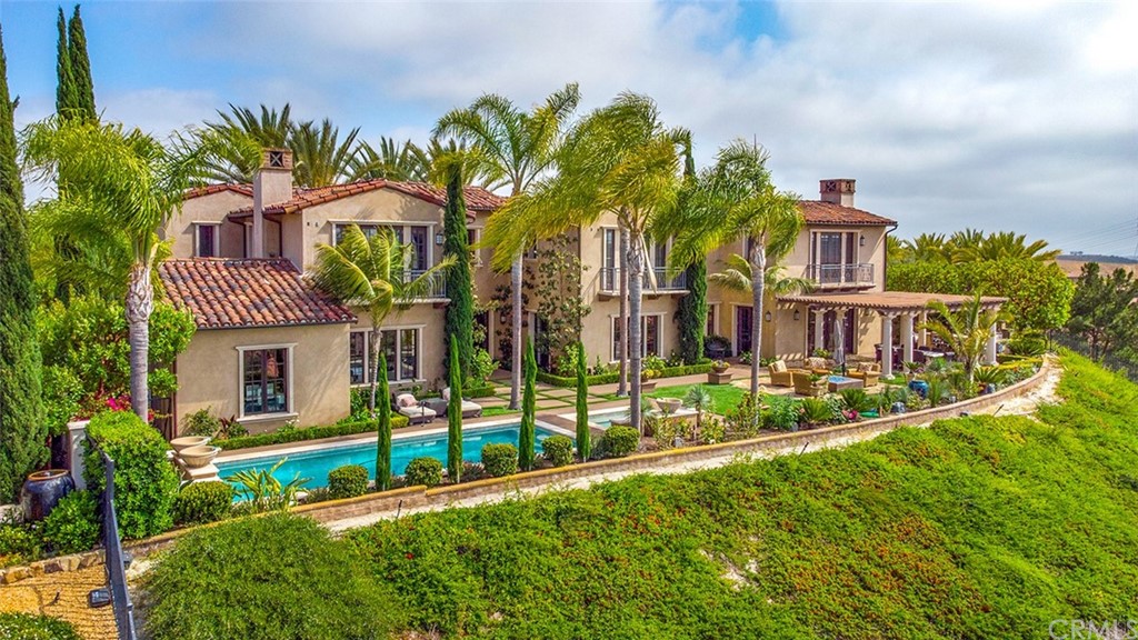 1 Thomas Road Ladera Ranch, CA 92694 - Photo 10 of 25 a view of a house with many windows and a yard