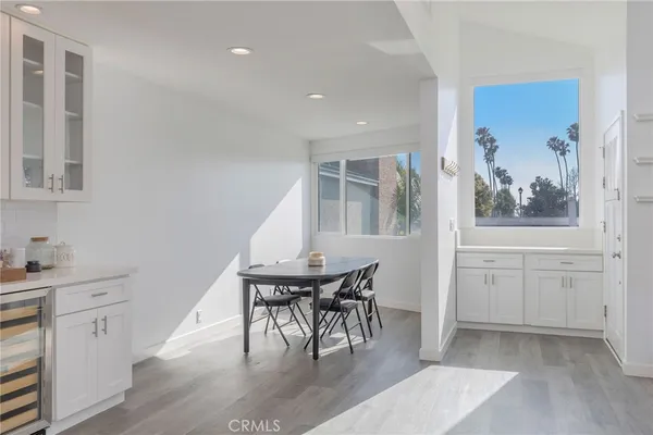 a view of a hallway with furniture and chandelier