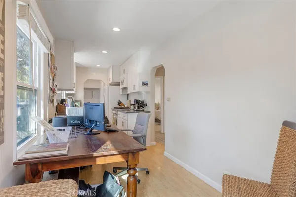 a kitchen with stainless steel appliances a sink a stove and a wooden floors