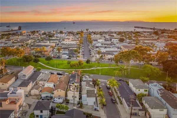 an aerial view of residential houses with outdoor space and river