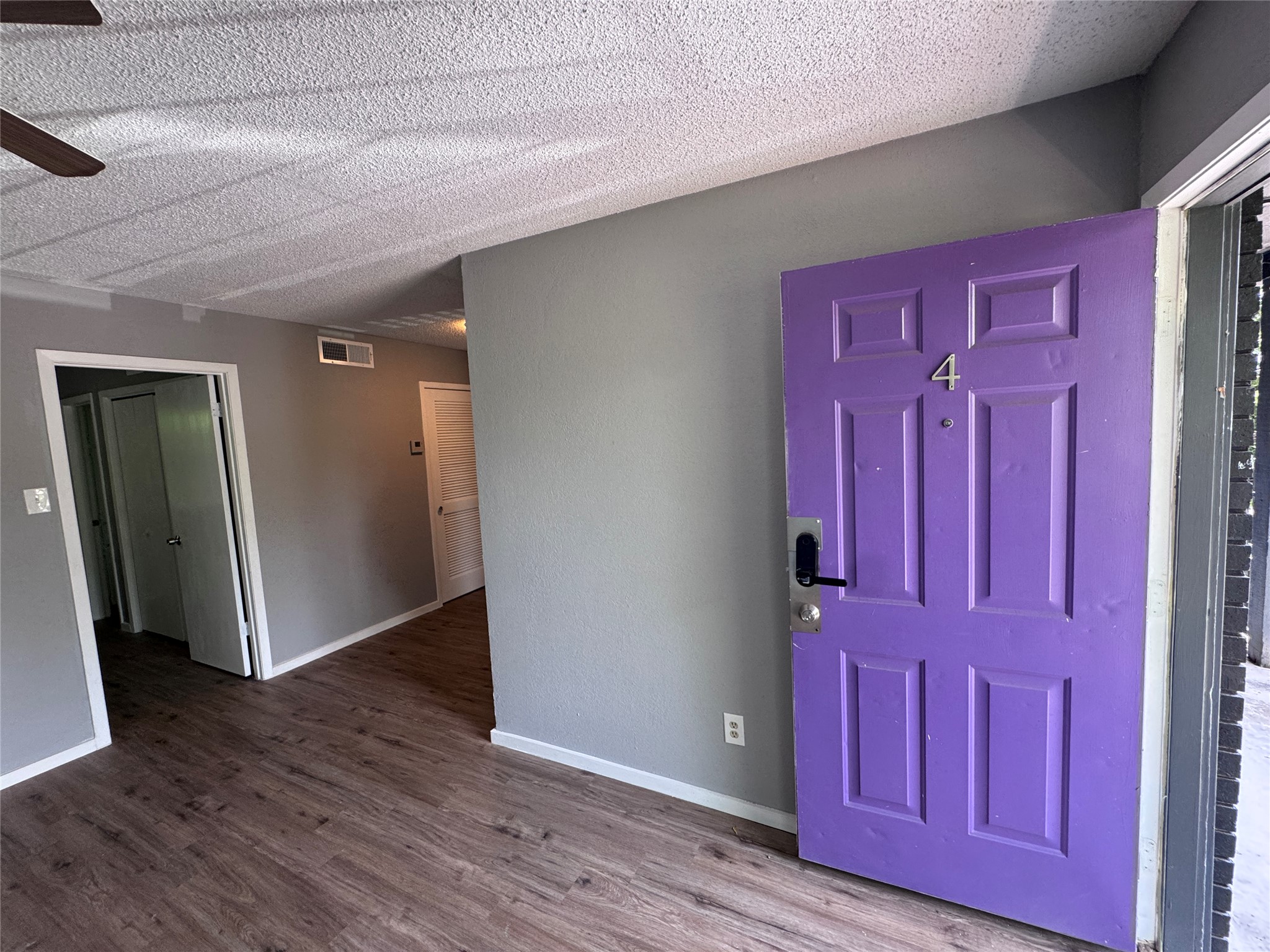 309 East Dean Avenue, Unit 2 Killeen, TX 76541 - Photo 4 of 13 wooden floor with red door