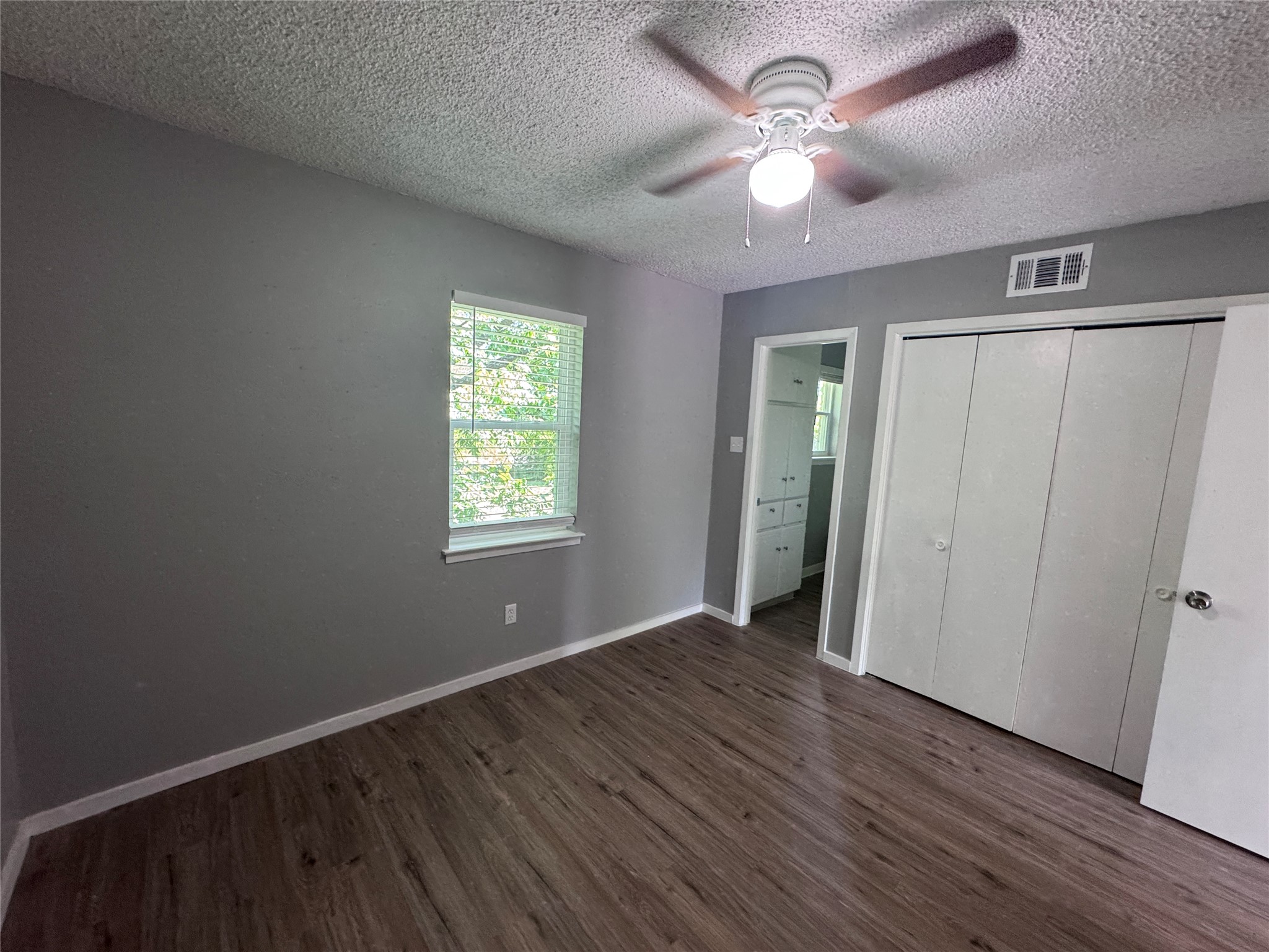 309 East Dean Avenue, Unit 2 Killeen, TX 76541 - Photo 10 of 13 a view of an empty room with window and wooden floor
