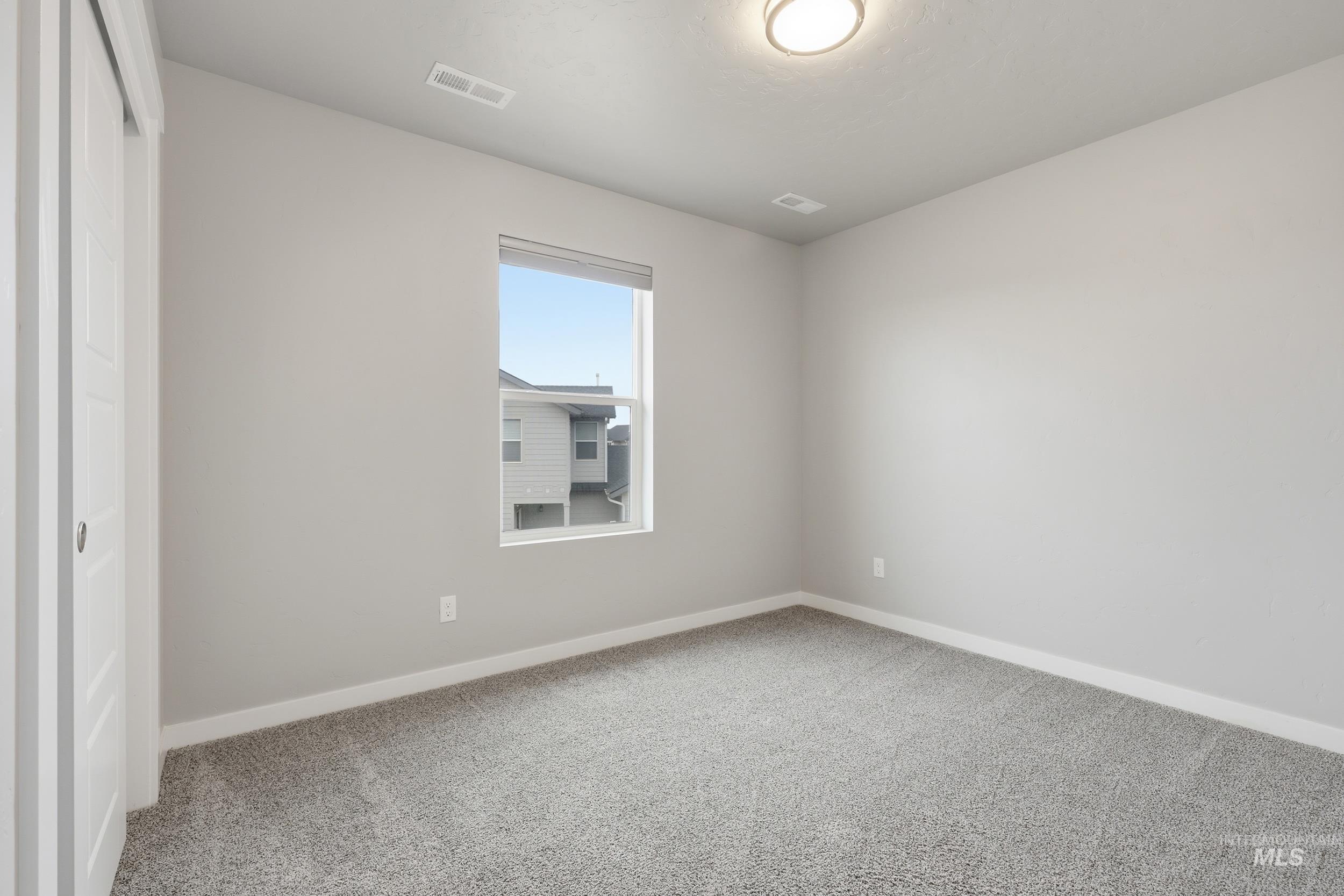 1097 North World Cup Lane Eagle, ID 83616 - Photo 31 of 42 Spare room with baseboards and light carpet