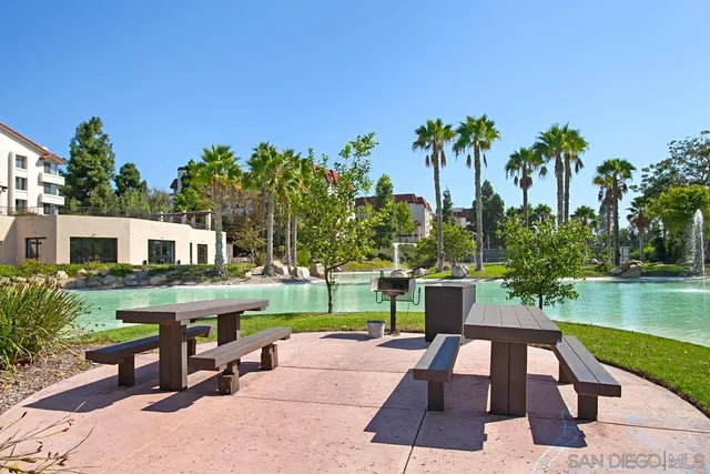a view of a house with swimming pool and sitting area