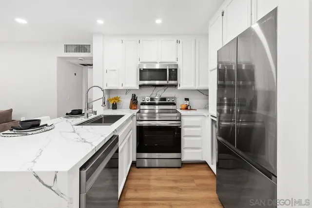 a kitchen with a sink stove and refrigerator