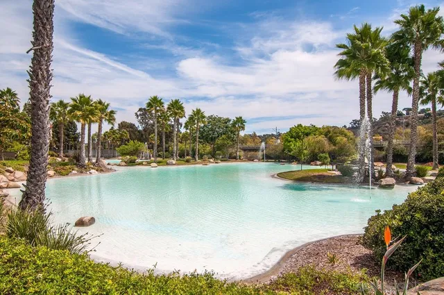 a view of a house with swimming pool and sitting area