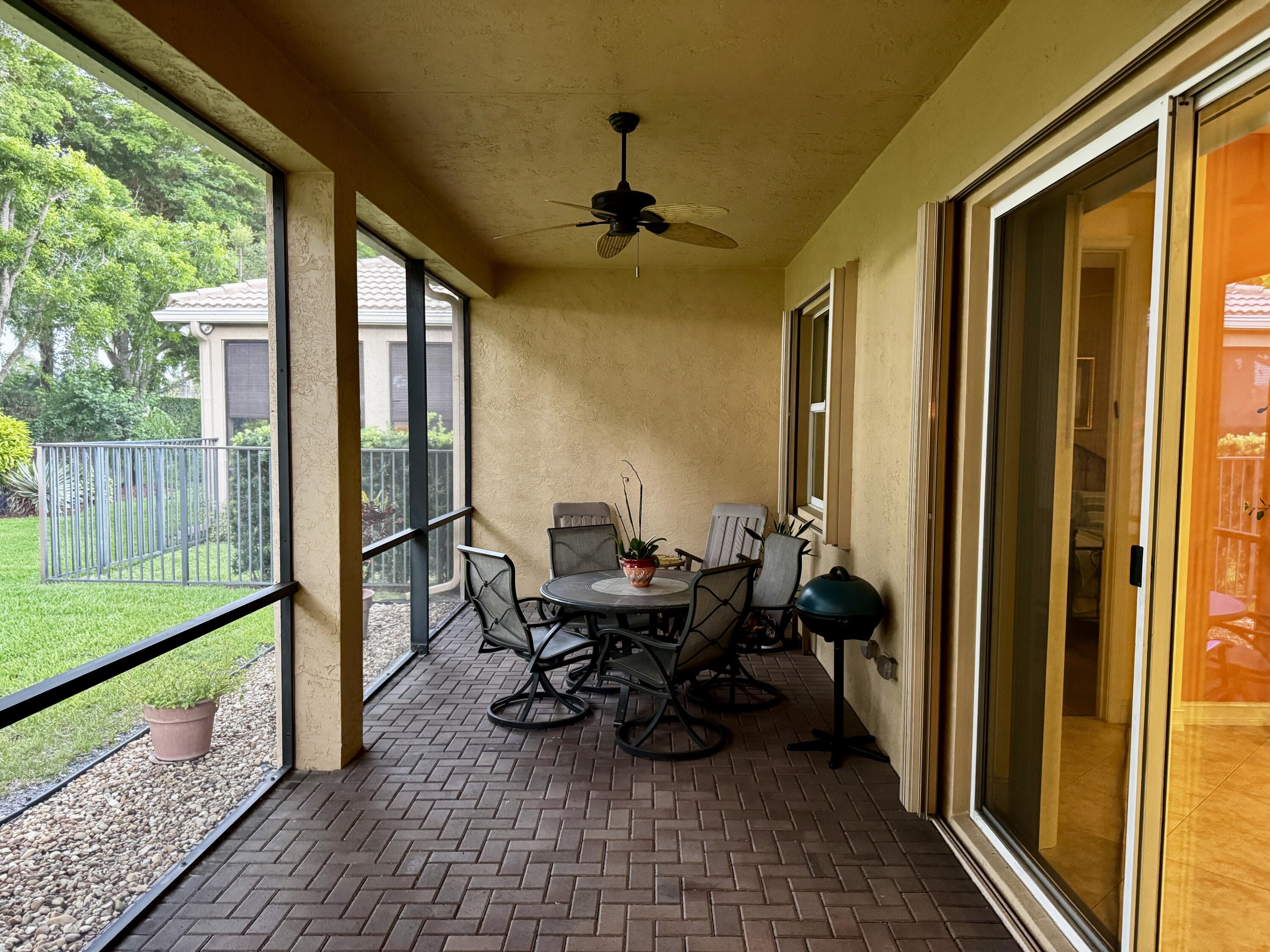 9385 Ivory Isle Road Boynton Beach, FL 33473 - Photo 16 of 50 a view of a porch with furniture and yard