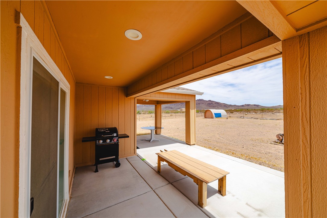 2948 Pinal Road Golden Valley, AZ 86413 - Photo 36 of 59 Covered patio with recessed lighting, concrete flooring, and a sliding glass door