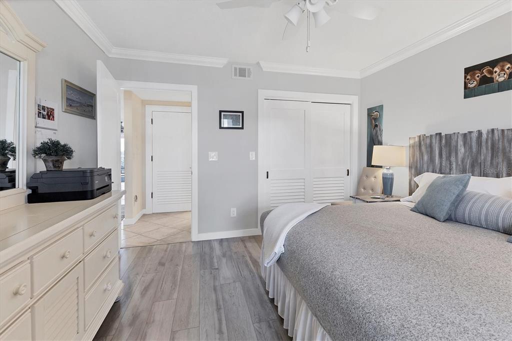 11000 Placida Road, Unit 302 Placida, FL 33946 - Photo 28 of 68 a bed room with a bed and a large mirror
