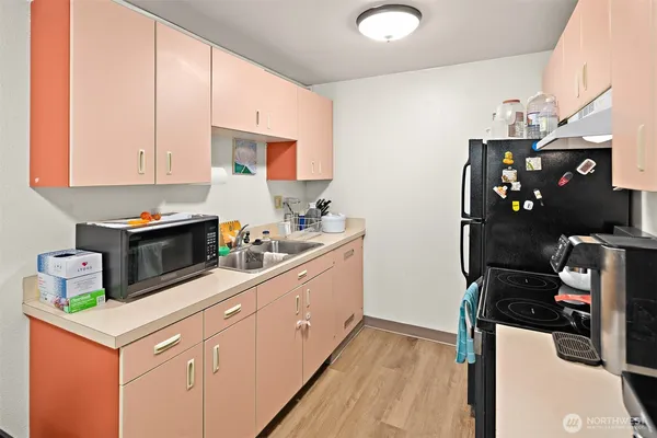 a kitchen with a sink a stove and cabinets