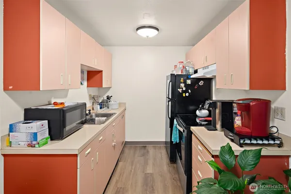 a kitchen that has a sink and a stove in it