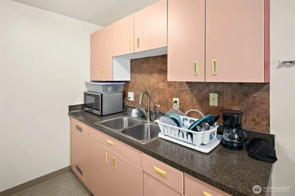 a kitchen with a sink and cabinets