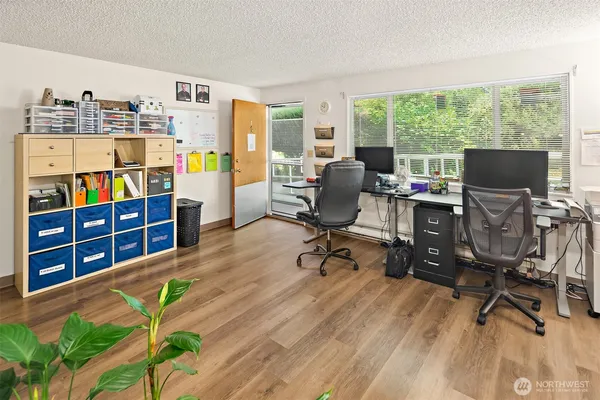 a view of a workspace with furniture and a window