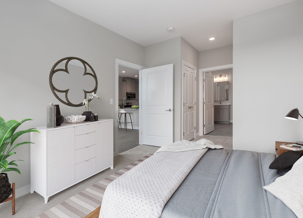 72 Flint Street, Unit 1106 Salem, MA 01970 - Photo 4 of 13 a bedroom with a bed and a potted plant