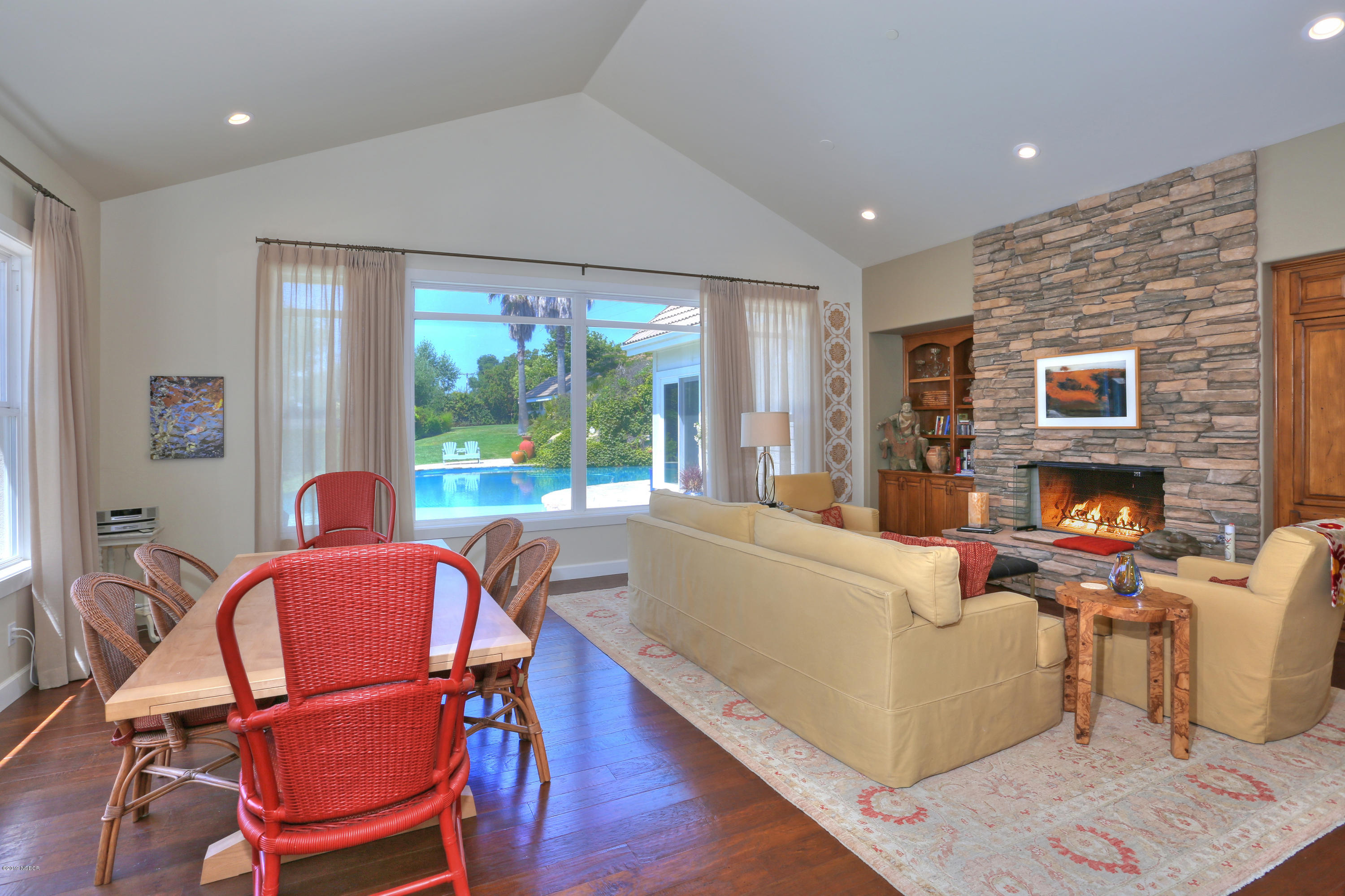 959 Old Ranch Road Solvang, CA 93463 - Photo 20 of 29 a living room with furniture a fireplace and a floor to ceiling window