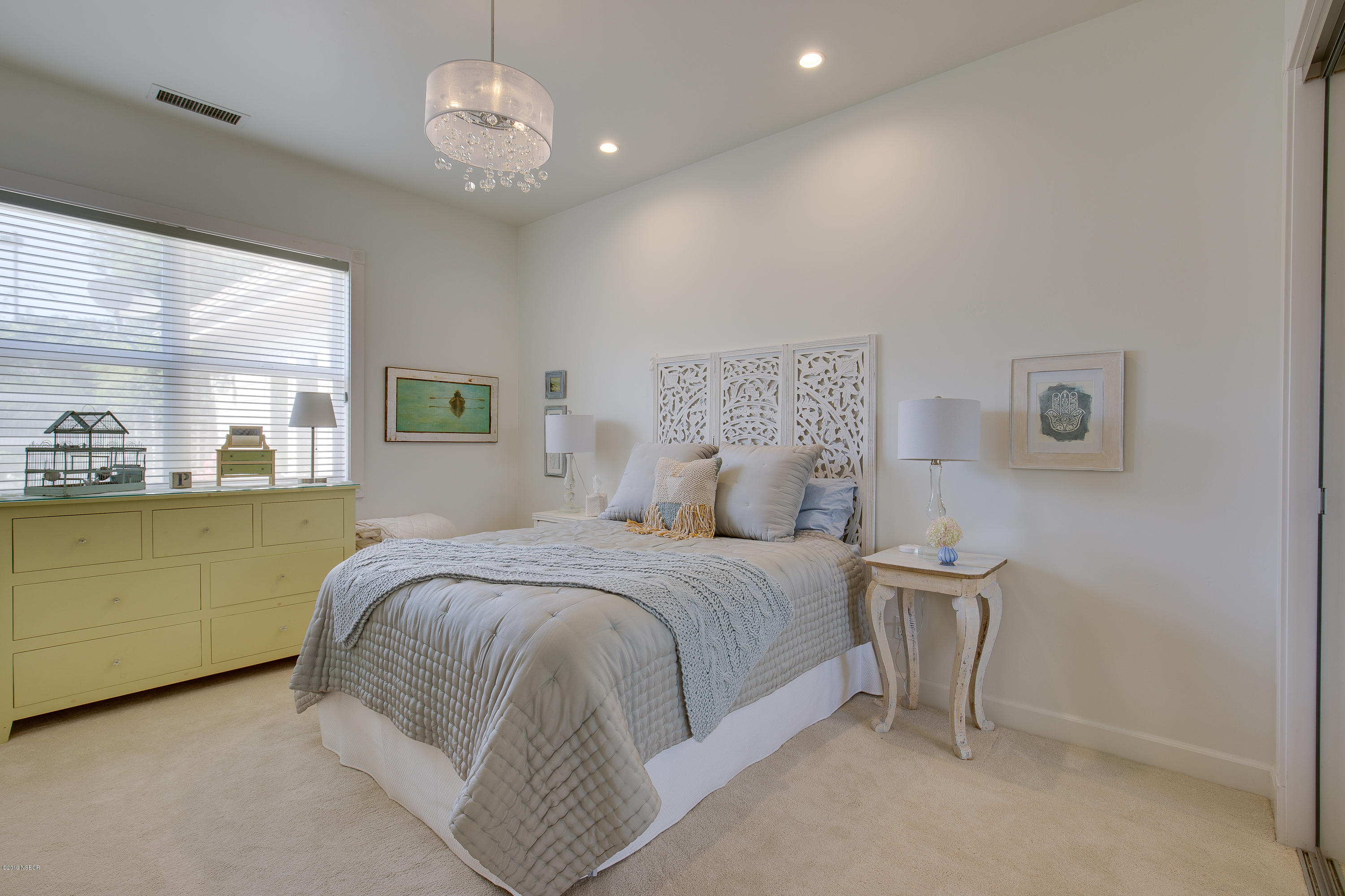 959 Old Ranch Road Solvang, CA 93463 - Photo 24 of 29 a bedroom with a large bed and a chandelier
