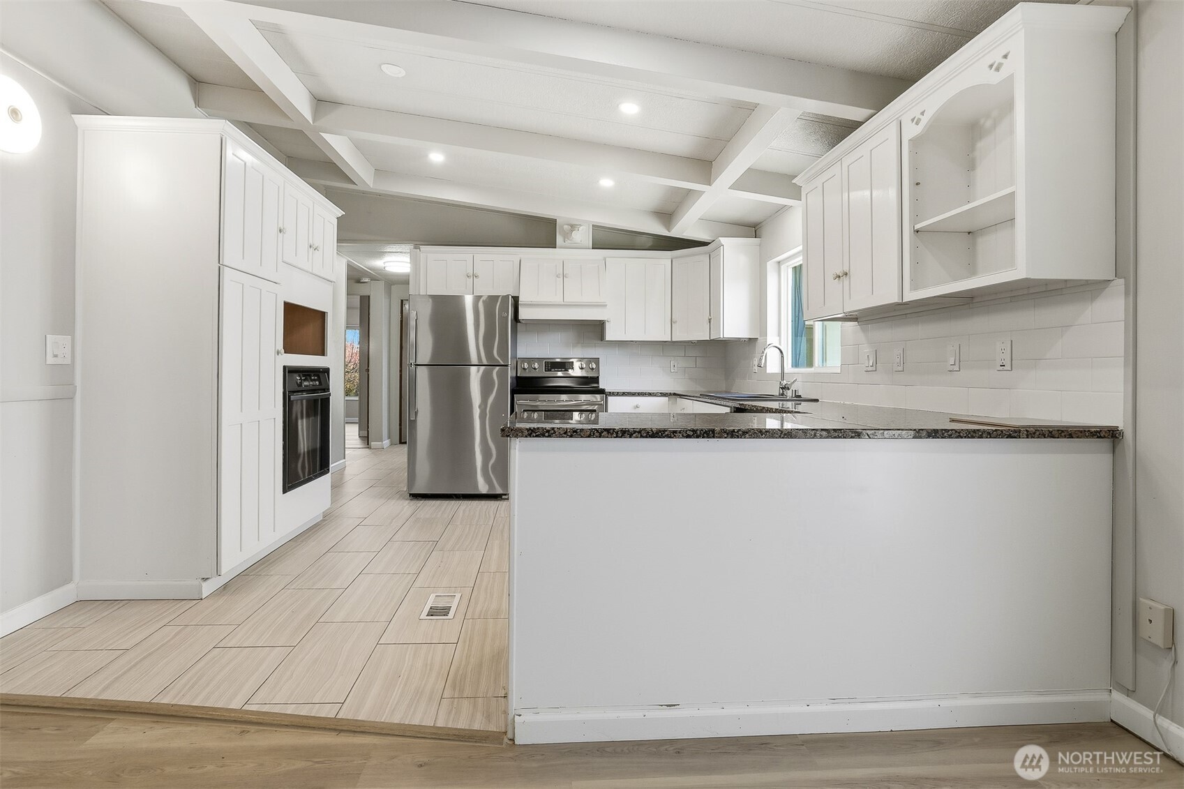 23728 Vista View Avenue Bothell, WA 98021 - Photo 15 of 40 a kitchen with stainless steel appliances granite countertop a refrigerator sink and cabinets