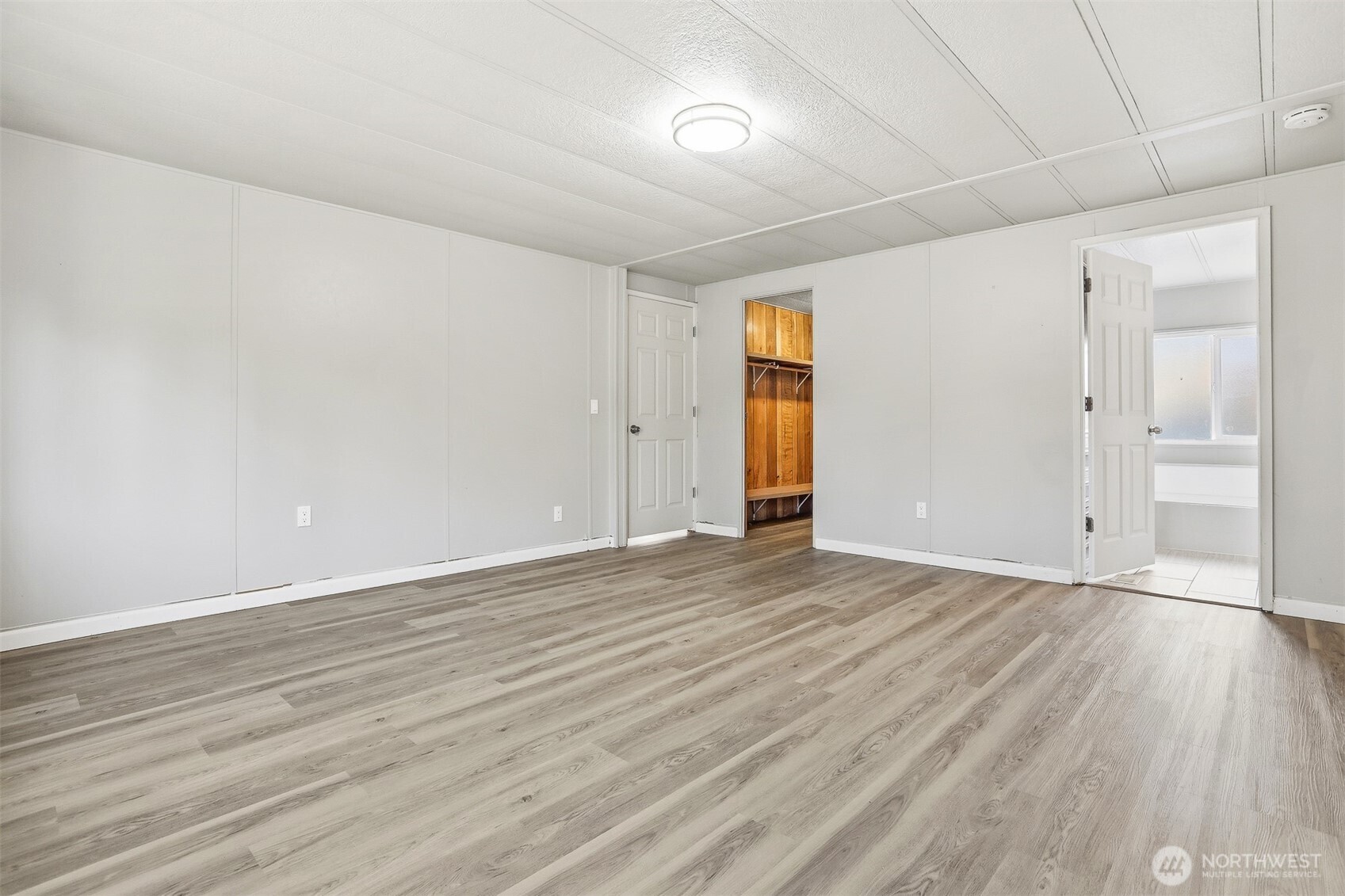 23728 Vista View Avenue Bothell, WA 98021 - Photo 17 of 40 a view of an empty room with wooden floor