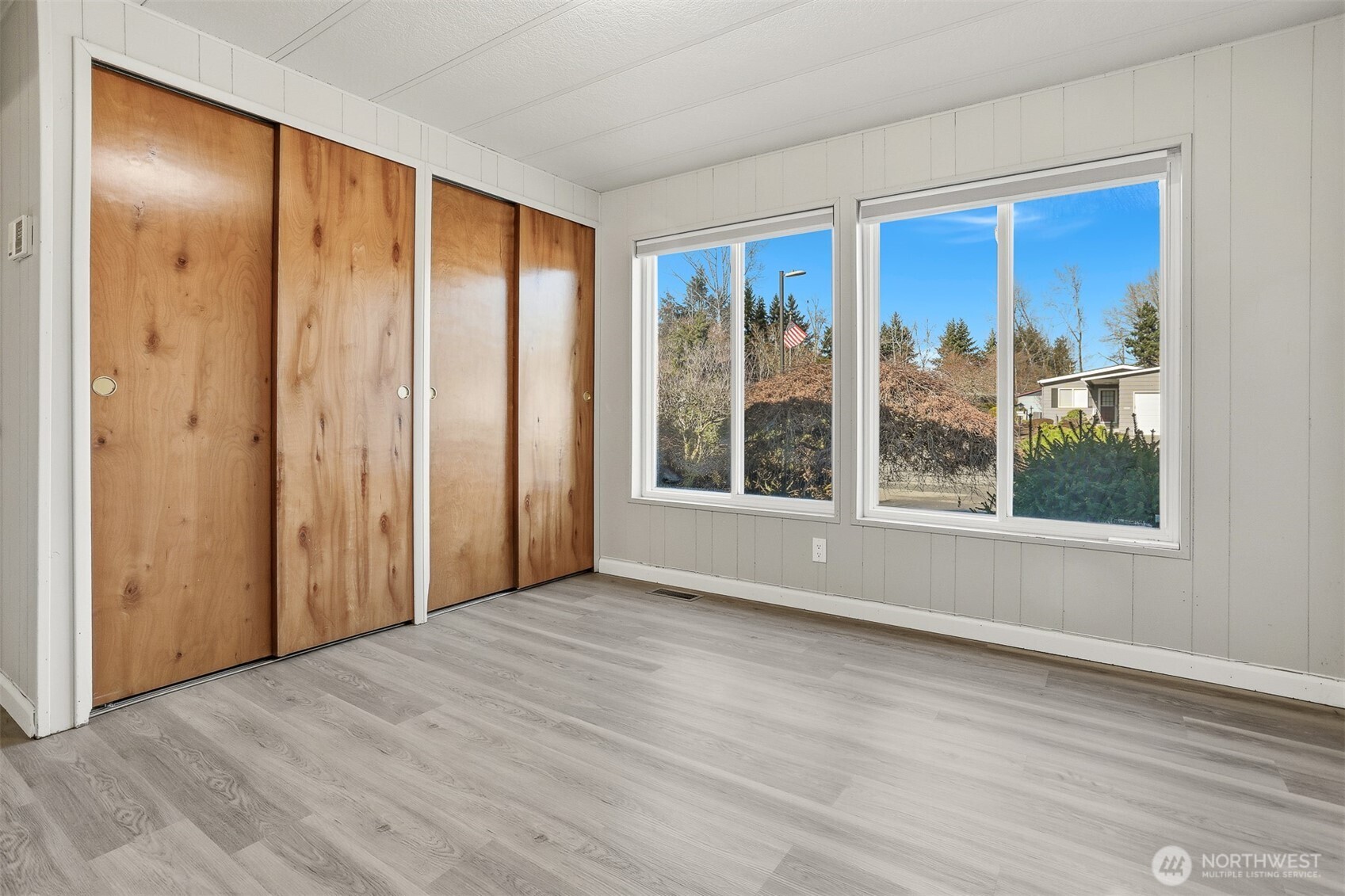 23728 Vista View Avenue Bothell, WA 98021 - Photo 22 of 40 a view of an empty room with wooden floor and a window