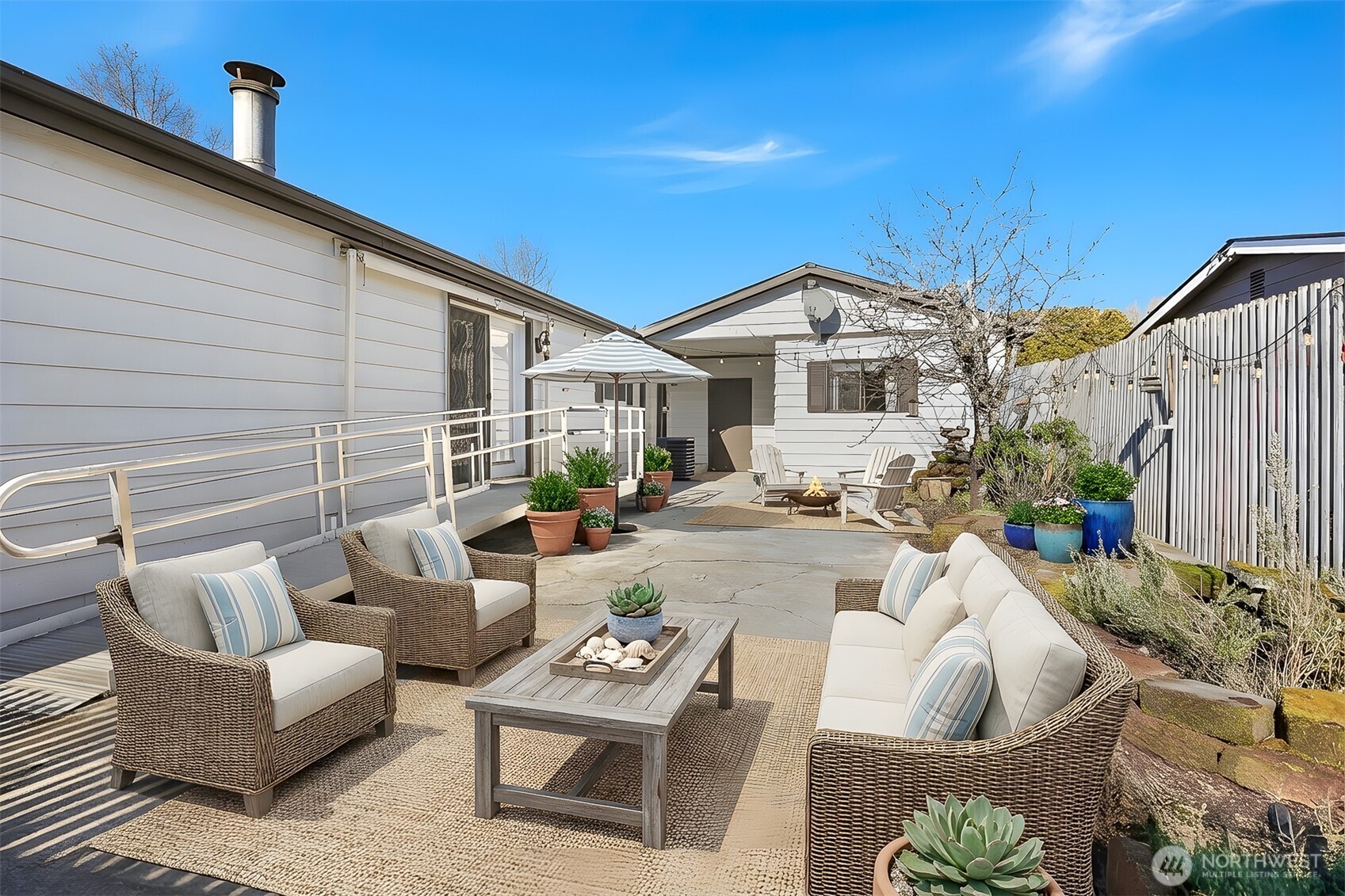 23728 Vista View Avenue Bothell, WA 98021 - Photo 29 of 40 a view of a patio with couches table and chairs with potted plants