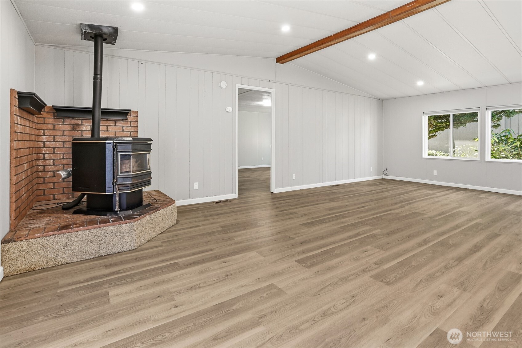 23728 Vista View Avenue Bothell, WA 98021 - Photo 7 of 40 a view of empty room with a fireplace and wooden floor