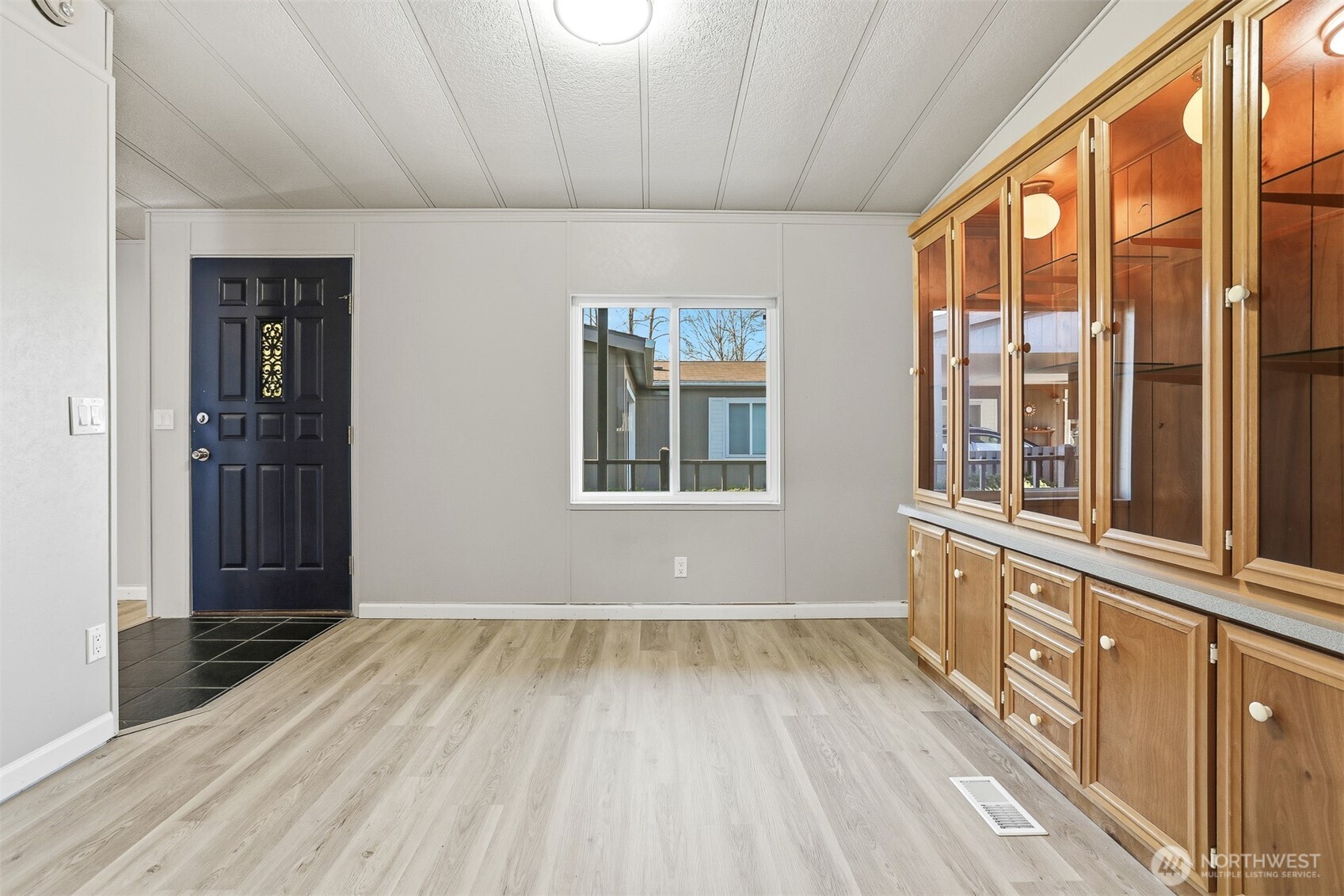 23728 Vista View Avenue Bothell, WA 98021 - Photo 10 of 40 a view of an empty room with wooden floor and a window