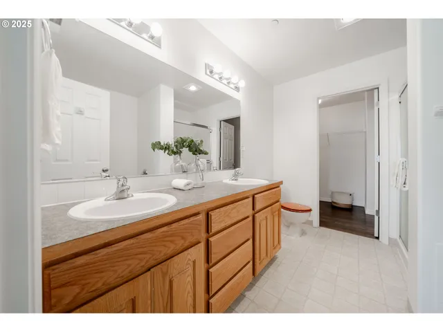 a bathroom with a double vanity sink and a mirror