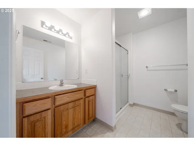 a bathroom with a shower and a glass door