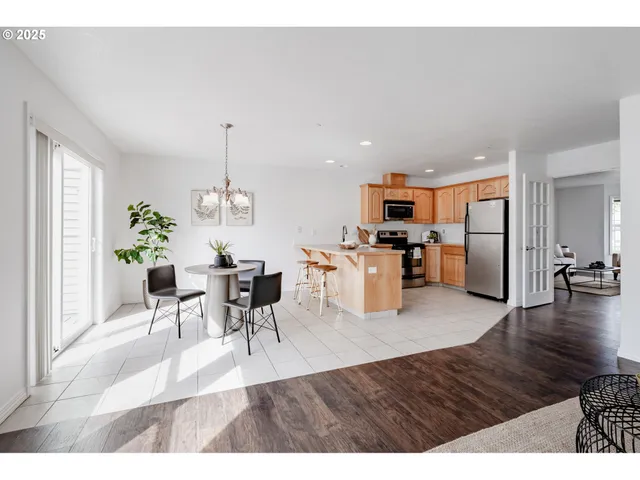 a living room with furniture and a kitchen view