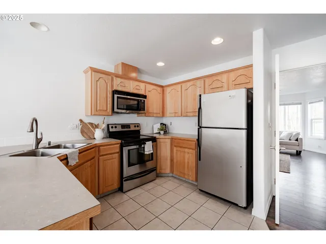 a kitchen with a refrigerator a microwave a sink and a stove