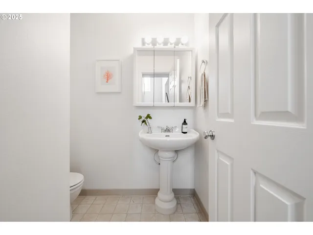 a bathroom with a sink a mirror and a window