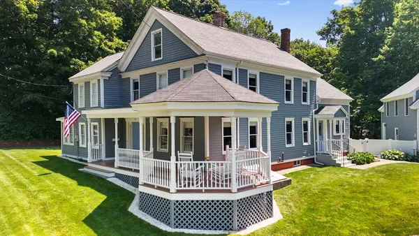 a view of a house with a yard and deck