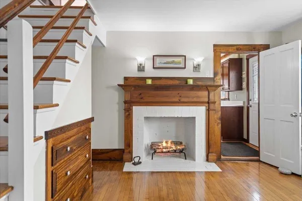 a living room with a fireplace and a wooden floor