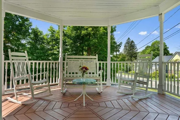 a view of a deck with a floor to ceiling window and wooden fence