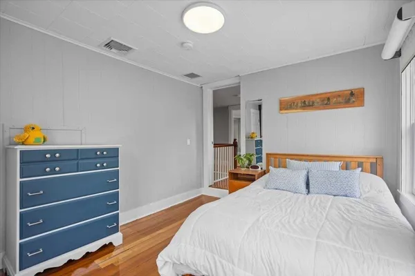 a bedroom with a bed and a dresser