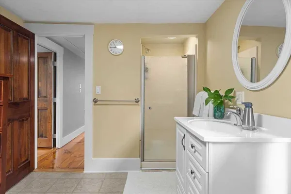 a bathroom with a sink a mirror and a shower