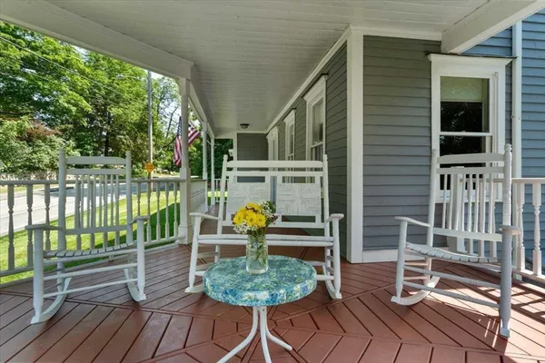 a view of a chair and tables in the balcony