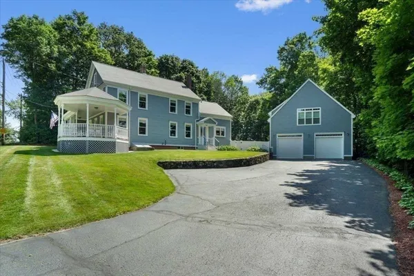 a front view of a house with a garden and yard