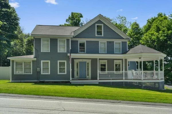 a front view of a house with a garden