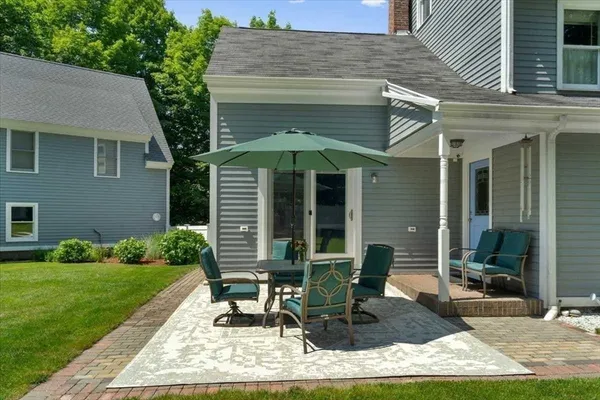 a front view of a house with garden and patio