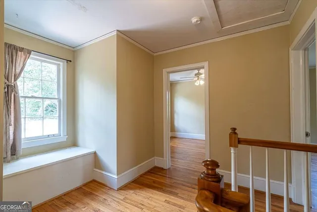 a view of a room with wooden floor and windows